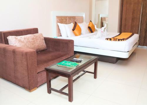 a living room with a couch and a coffee table at Hotel Shri Radha Nikunj - Opposite Prem Mandir in Vrindāvan
