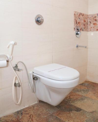 a bathroom with a toilet and a shower at Hotel Shri Radha Nikunj - Opposite Prem Mandir in Vrindāvan
