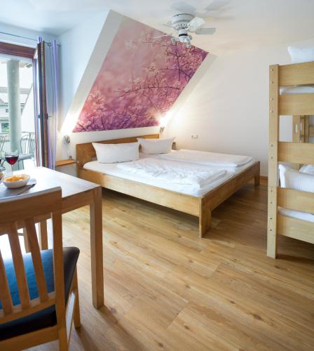 a bedroom with a large bed and a ladder at Ruster Drachennest - Europa Park by living TIMELESS in Rust