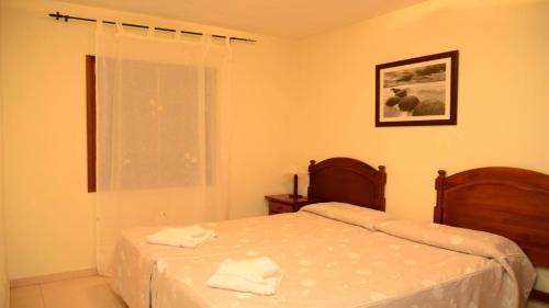 a bedroom with a bed with two towels on it at Apt. Heliconia Nº 5 in La Playa Calera