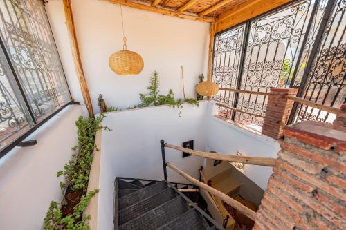 a hallway with windows and stairs in a building at Dar Karole-Privé-petits déjeuners inclus in Marrakech