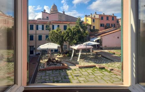 a view from a window of a courtyard with umbrellas at 3 Bedroom Stunning Home In Montemarcello in Monte Marcello