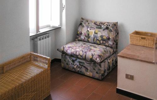 a living room with a couch and a chair at 3 Bedroom Stunning Home In Montemarcello in Monte Marcello
