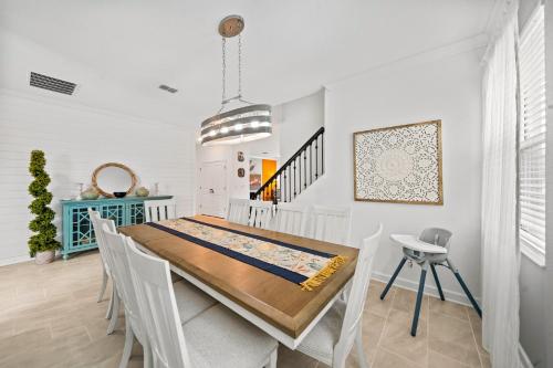 a dining room with a wooden table and chairs at 390 Strand Drive in Melbourne Beach