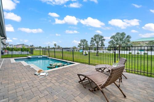 a patio with two chairs and a swimming pool at 390 Strand Drive in Melbourne Beach