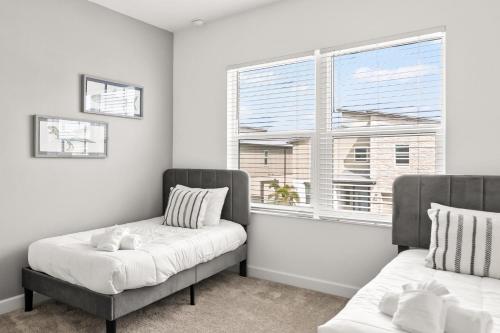 two beds in a room with a window at 390 Strand Drive in Melbourne Beach
