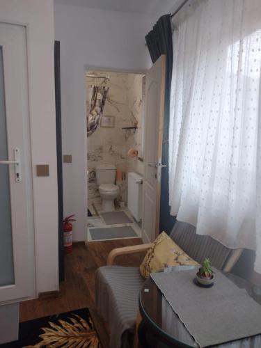 a living room with a toilet and a couch at Roca Room in Atias