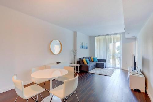 a living room with a table and a couch at Apartment in Casa Costa condo!Beach pass included in Boynton Beach