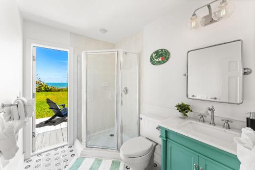 a bathroom with a shower and a toilet and a sink at 5435 Highway A1A in Melbourne Beach