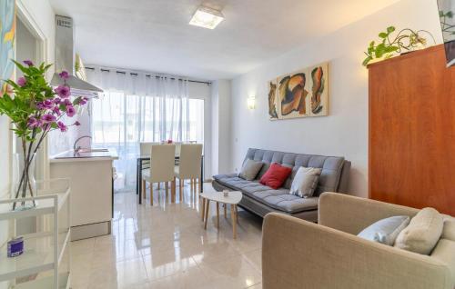 a living room and kitchen with a couch and a table at 1 Bedroom Cozy Apartment In Torremolinos in Torremolinos