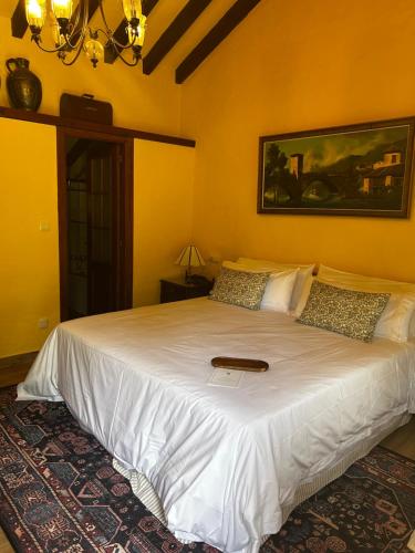 a bedroom with a bed with a book on it at Hotel Boutique Santuario Kunturi - Adults Only in Llanes