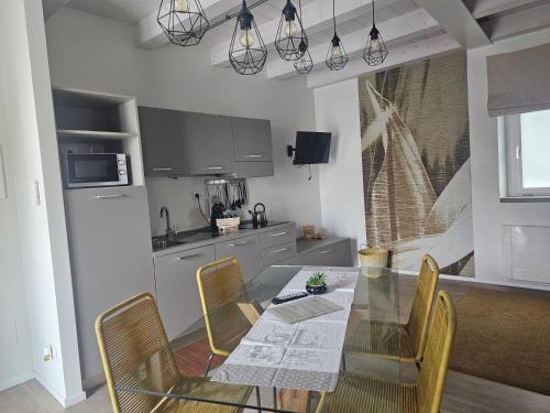 a kitchen with a dining room table and chairs at Appartamenti il borgo girasole in Busca
