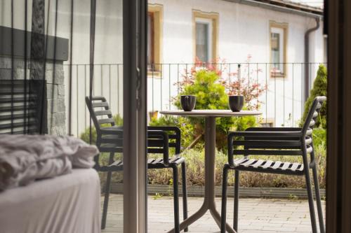 a patio with two chairs and a table with two cups at The Gast House Zell am See in Zell am See
