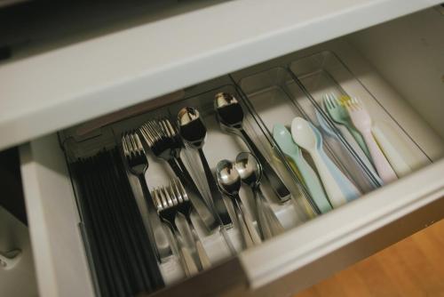a drawer filled with utensils and spoons and forks at Kumamoto Airport Villa 5 mins from Kumamoto Airport in Nishiharamura