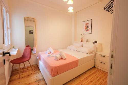 a bedroom with a bed and a chair and a mirror at AG Living One in Thessaloniki