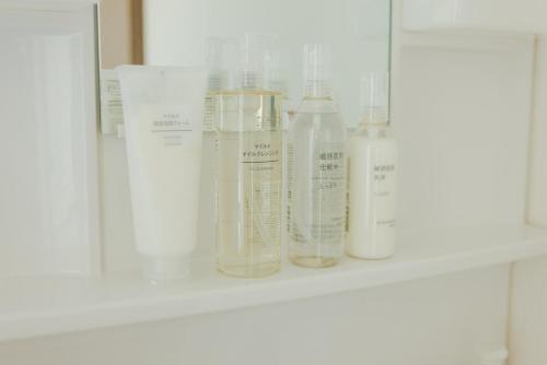 a shelf with four bottles on it at Kumamoto Airport Villa 5 mins from Kumamoto Airport in Nishiharamura