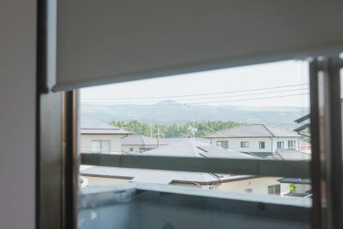 a view of a city from a window at Kumamoto Airport Villa 5 mins from Kumamoto Airport in Nishiharamura