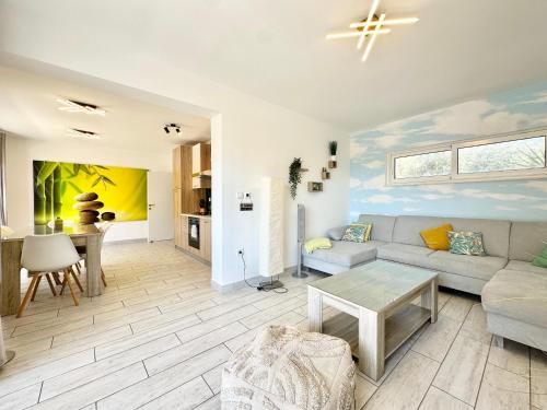 a living room with a couch and a table at Apartments Villa A - Heating Pool in Trogir