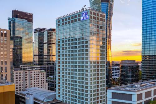 a tall building with a sign on it in a city at Hilton Warsaw City Hotel in Warsaw