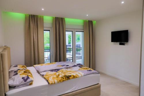 a bedroom with a bed with a flat screen tv at Casa Dellˇ Amore in Bihać