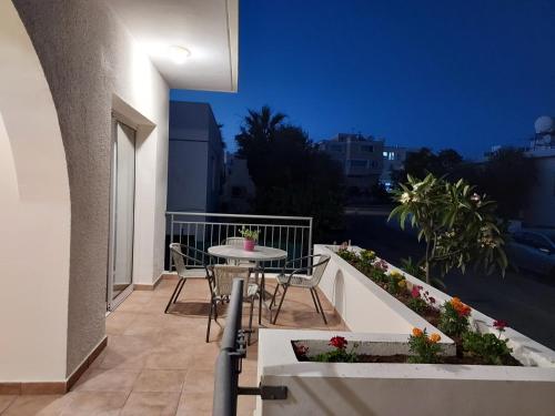 a patio with a table and chairs on a balcony at Ermioni's House in Ktima