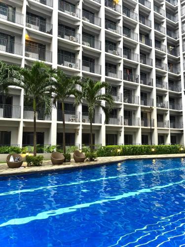 a swimming pool in front of a hotel at Philhaus Staycation 2025 in Manila