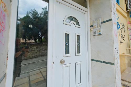 a white door with a person taking a picture at AG Living One in Thessaloniki