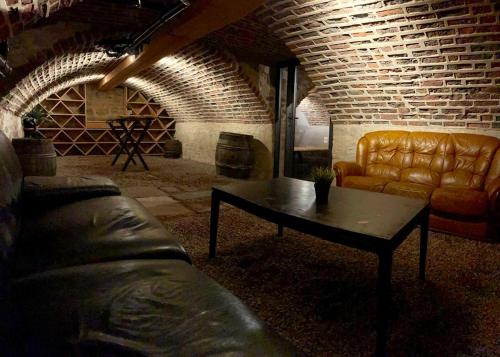 a living room with a couch and a coffee table at Gîte La Grenadine in Saint-Firmin