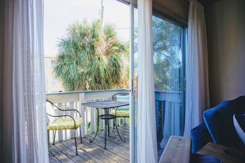 a balcony with a table and chairs and a window at Anna Maria Island Beach Shack Walk to Beach & Bay in Bradenton Beach