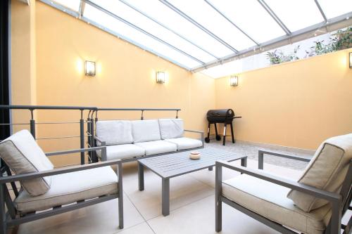 a living room with a couch and two chairs and a table at New Luxury - Entire Villa - AC - Climatisation - Sauna - Free Private Parking - Fully Equipped - From 1 to 6 guests in LʼHay-les-Roses