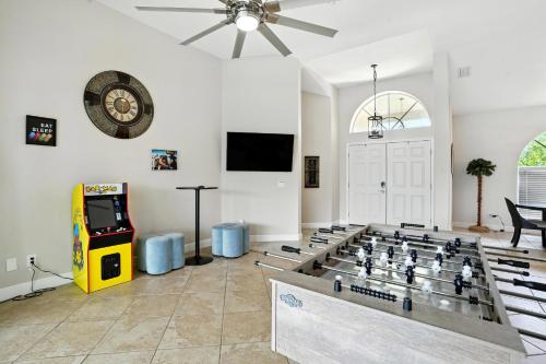 a living room with a chess board and a video game at Casa in The Cove in Cape Coral