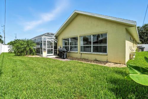 a house with a lawn in front of it at Casa in The Cove in Cape Coral