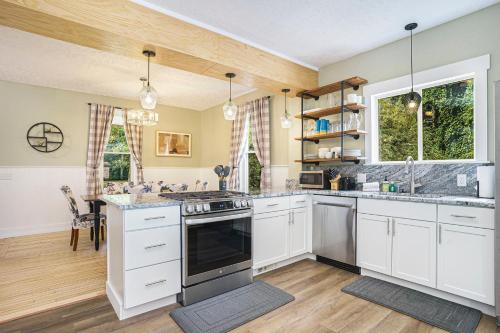 a kitchen with white cabinets and a stove top oven at Third Haven in South Haven