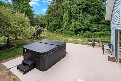 a large grill sitting on a patio with chairs at Third Haven in South Haven
