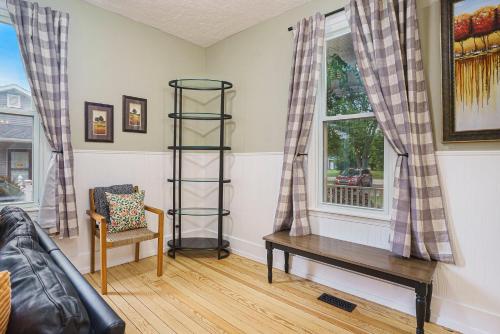 a living room with a bench and a window at Third Haven in South Haven