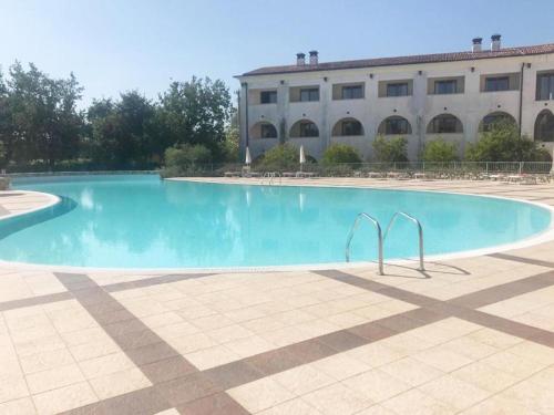 a large swimming pool in front of a building at The Artist - Apartments with Private Garden in Residence with Pool in Manerba del Garda