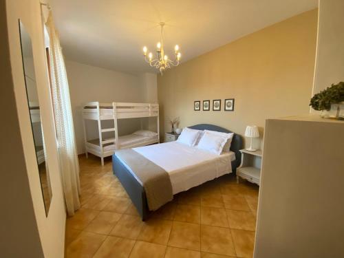 a bedroom with a bed and a bunk bed at Casa Marcobando - Lucca in Lucca