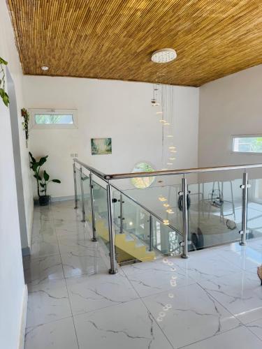 a staircase in a room with a wooden ceiling at Grace house jacuzzi in Saly Portudal
