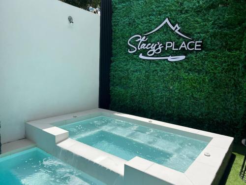 a swimming pool with a sign in the grass at Stacys Place #4 Studio Apartment in Port-of-Spain