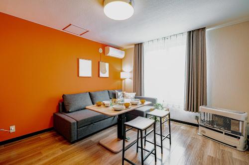a living room with a couch and a table at 南9西20戸建 in Sapporo