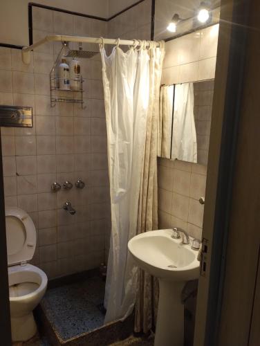 a bathroom with a toilet and a sink and a shower at Toto in San Juan