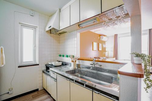 a small kitchen with a sink and a window at 南9西20戸建 in Sapporo