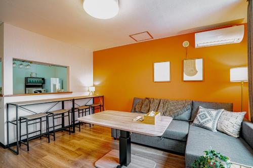 a living room with a couch and a table at 南9西20戸建 in Sapporo