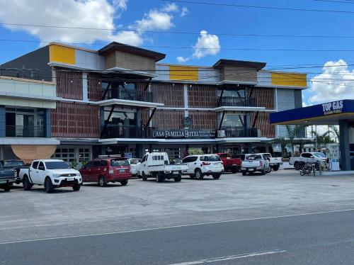 a parking lot with cars parked in front of a building at Casa Familia Hotel in Aurora