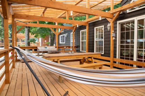 a hammock on the deck of a house at 森と湖の楽園ＷorkshopＣampＲesort in Fujikawaguchiko