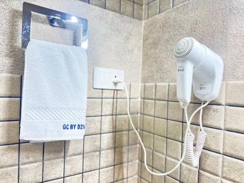 a bathroom with a blow dryer and a towel at Nova Grand Canyon in Cochin