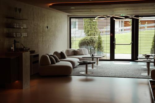 a living room with a couch and a table at HELD - Hotel & Spa , 4 Sterne Superior, Zillertal in Fügen