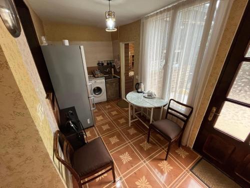 a small kitchen with a table and chairs in a room at Feel Old Tbilisi in Tbilisi City