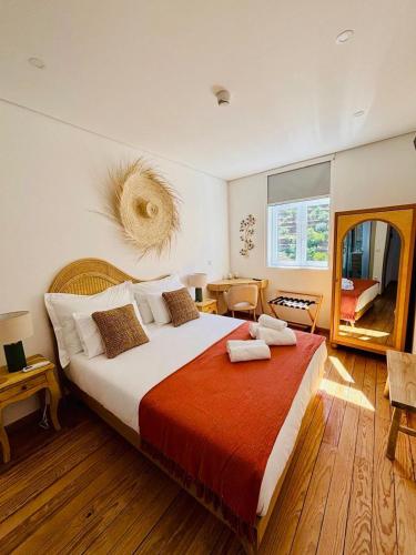 a bedroom with a large bed with a red blanket at Casa Tawny in Pinhão