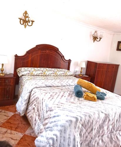 a bedroom with a large bed with a wooden headboard at El Azahar in Seville